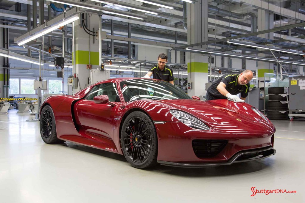 As the Porsche 918 Spyder production ends, two Porsche factory workers are seen here performing the final audit of the last Porsche 918 Spyder, crimson in color with black 918 wheels, in the Stuttgart-Zuffenhausen manufactory. Credit: Porsche