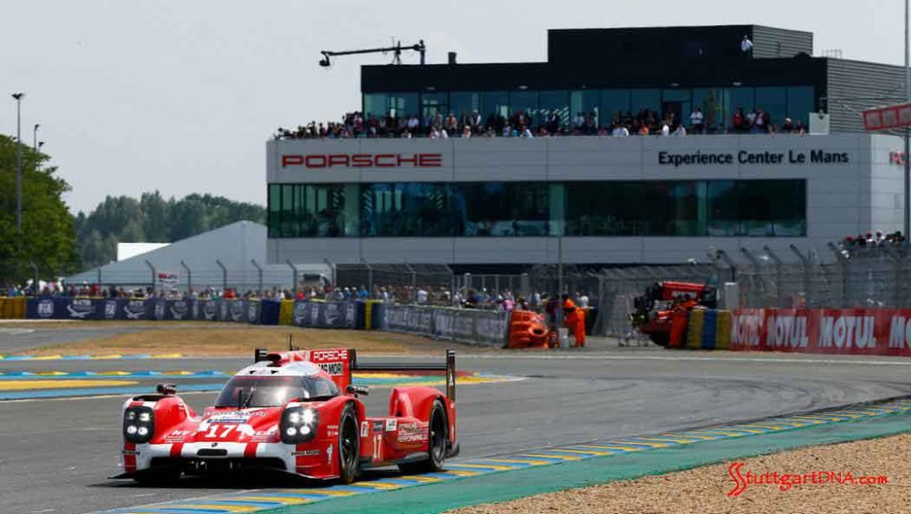 Porsche opens Le Mans Experience Center: The new Porsche Experience Center Le Mans, in b.g. of the No. 17 Porsche 919 Hybrid running on the track. Credit: Porsche AG