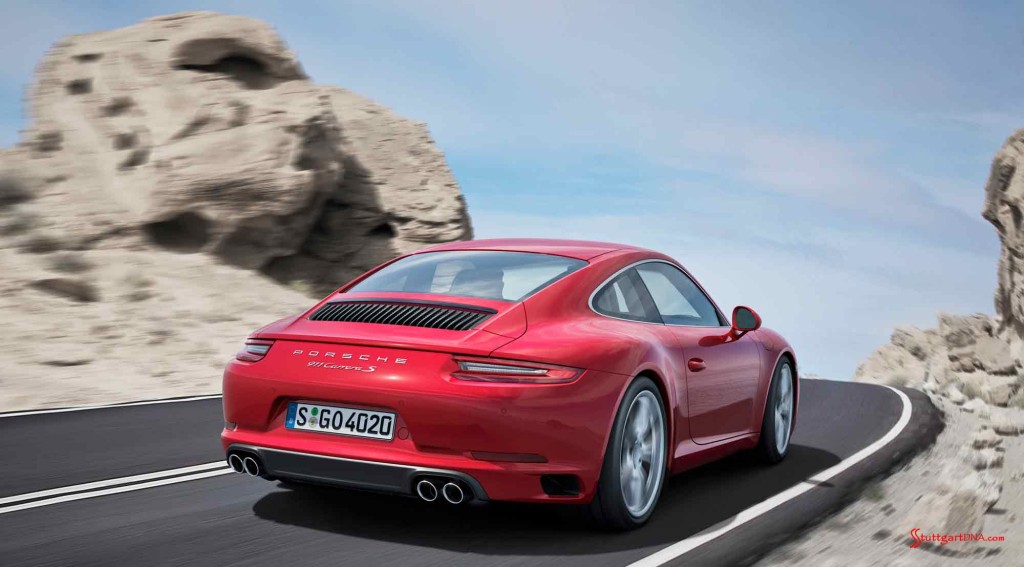 The new 2017 Porsche 911 Carrera 991.2: Seen her is a beautiful, new Porsche 911 Carrera S coupe in red, from-right-rear, carving the turns along a rocky road. Credit: Porsche AG