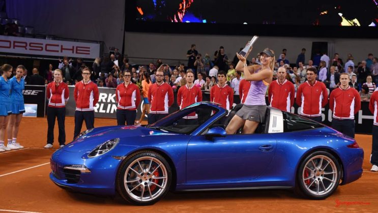 Maria Sharapova 2017 early professional tennis comeback: Maria Sharapova is seen in this photo at the Porsche Arena as Porsche Tennis Grand Prix 2014 winner, standing in a blue 911 Targa. Credit PAG