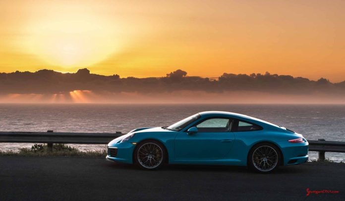 How buying a new Porsche can save you money: Seen in the pretty shot is a Miami Blue Carrera, left side, at sunset. Credit: PCNA