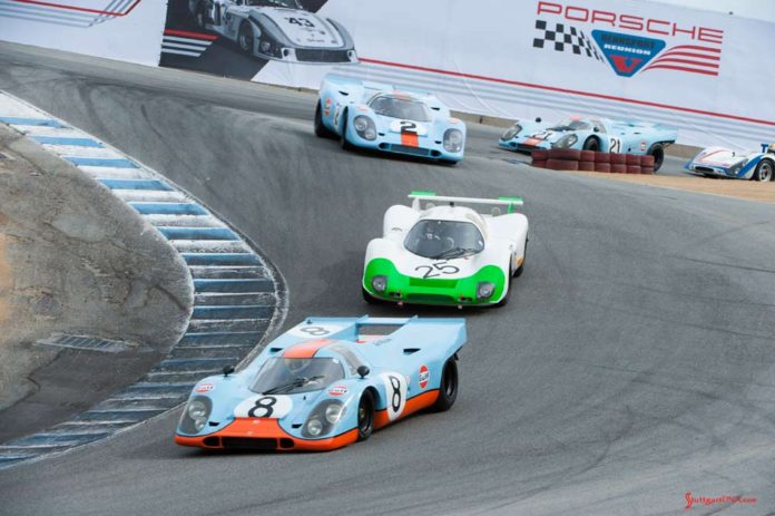 Porsche unveils official Rennsport Reunion VI poster - Rennsport Reunion V: We see here Porsche Gulf-liveried 917s and other Porsche racecars winding down Laguna Seca's famed Corkscrew at the 5th Reunion. Credit: Porsche AG