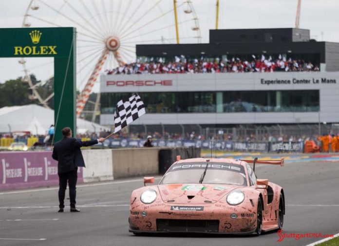 Porsche wins both 2018 Le Mans 24-Hour GT classes: Seen here in vivid relief is the No 92 Pink Pig RSR tking th checkered flag, with PEC in bg. Credit: Porsche AG