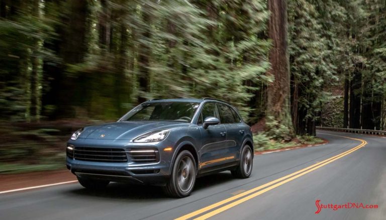 March 2019 Porsche USA sales: A blue 2019 Cayenne E3 is seen driving on a winding road through a dense forest of redwoods. Credit: Porsche AG