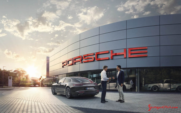 2019 Premier Porsche Dealers list announced: Pictured here is a Porsche dealership's facade at sunset, with the archetypical bold PORSCHE signage lit up in Guards Red. Credit: Porsche AG