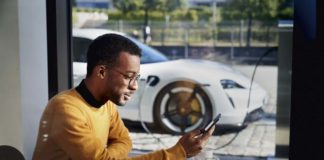 Porsche launches Porsche Finder, its pre-owned vehicle search platform Porsche launches Porsche Finder, its pre-owned vehicle search platform - Pictured here is an African American man operating his smartphone, with his Taycan charging in b.g. Credit: PCNA