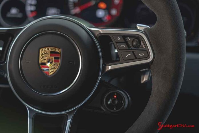 Porsche second-quarter 2020 USA retail sales: Seen here is the Porsche crest centered on the steering wheel of a Porsche 911. Credit: Porsche AG.