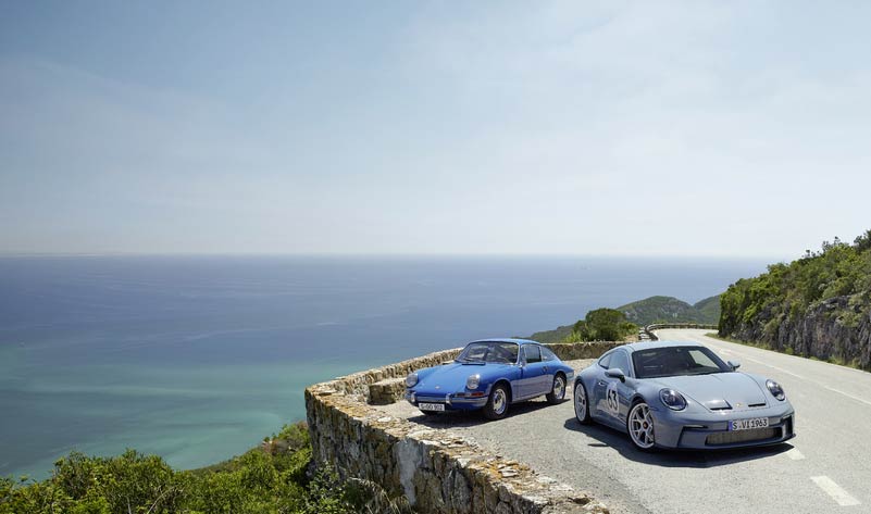 911-S/T - Scenically pictured here is a 911-S/T and a 911 2.0 parked in a mountain-road turnout, overlooking a beautiful ocean vista. Credit: Porsche AG