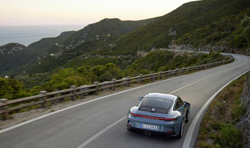 911-S/ T - Scenically pictured here is a 911-S/ T, from the rear, sweeping along a winding mountain road. Credit: Porsche AG