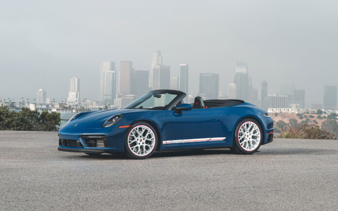 Porsche recalls 911 for seat-belt retractor issues: Depicted here in this picturesque image is a Blue 911 GTS Cabriolet America set against the L.A. skyline above Dodger Stadium. Credit: Porsche AG