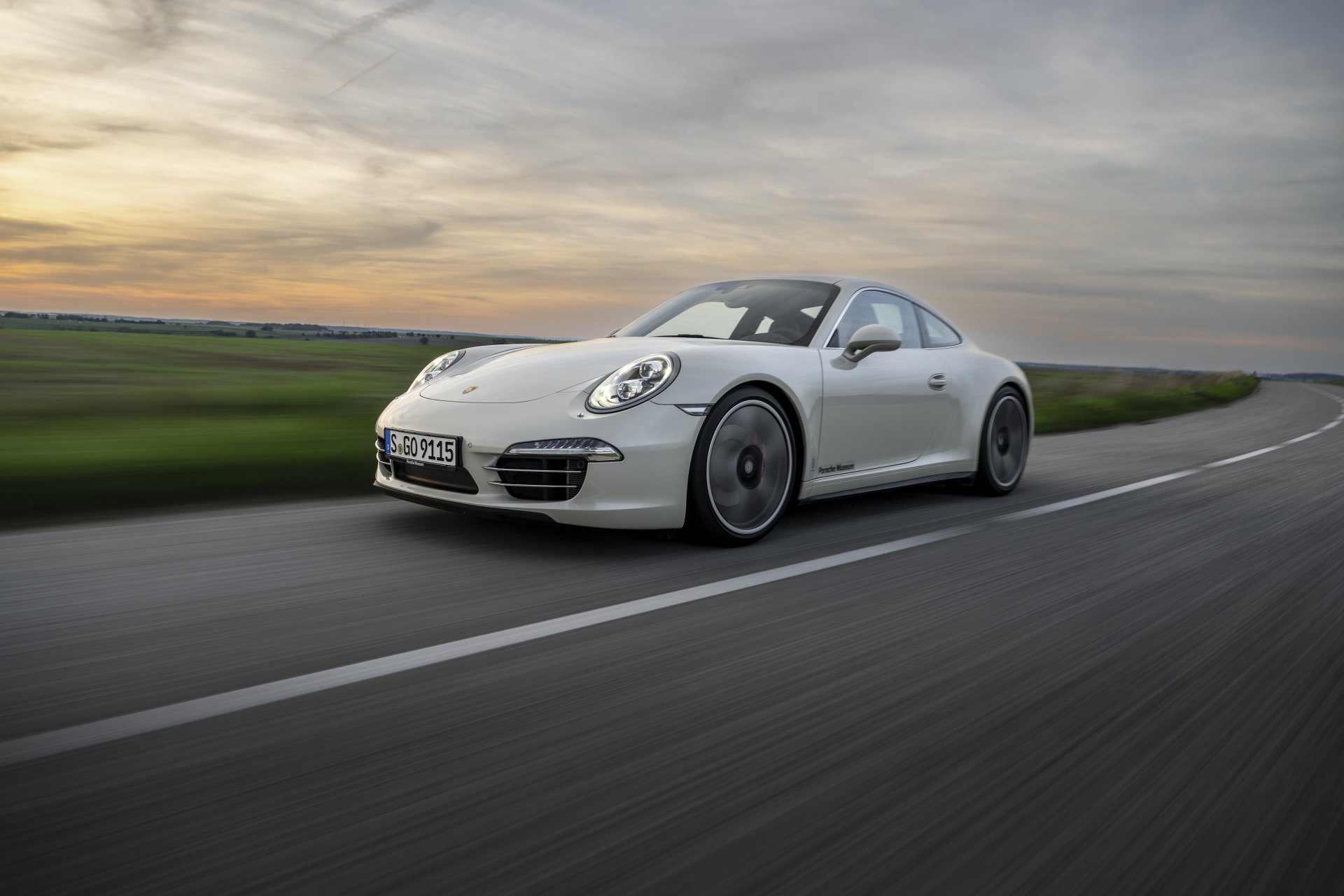 991.1-Gen Porsche 911 Buyer Guide: Pictured here is a 991.1 - 50th Anniversary - left-front corner at speed. Credit: Porsche AG