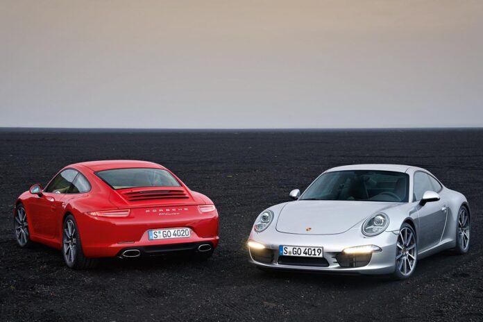 991.1-Gen Porsche 911 Buyer Guide: Depicted here are a Orange 991.1 Carrera and a Silver 991.1 S on black rock. Credit: Porsche AG