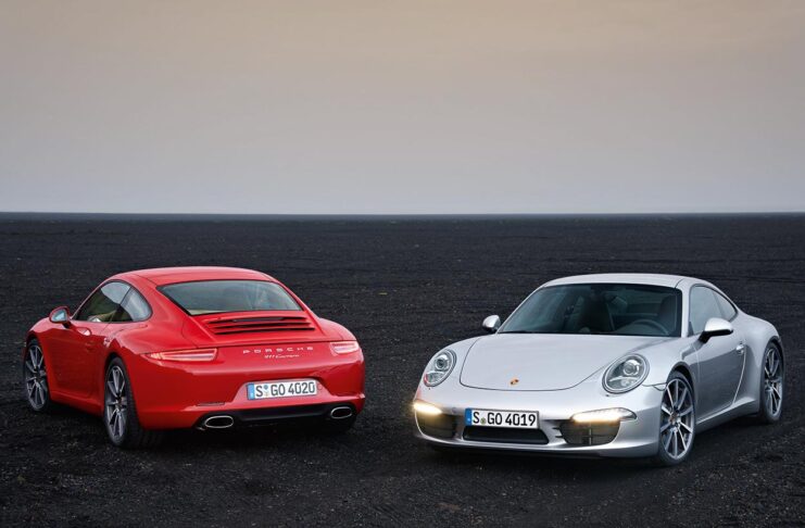 Essential 991.1-Gen Porsche 911 Buyer Guide 2026 by StuttgartDNA 991.1-Gen Porsche 911 Buyer Guide: Depicted here are a Orange 991.1 Carrera and a Silver 991.1 S on black rock. Credit: Porsche AG