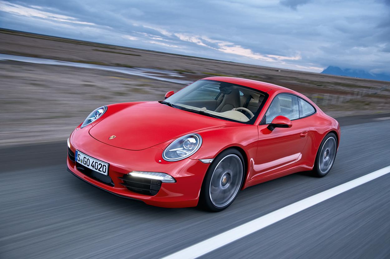991.1-Gen Porsche 911 Buyer Guide: Pictured here is an Orange 991.1 Coupe at speed - left-front corner. Credit: Porsche AG