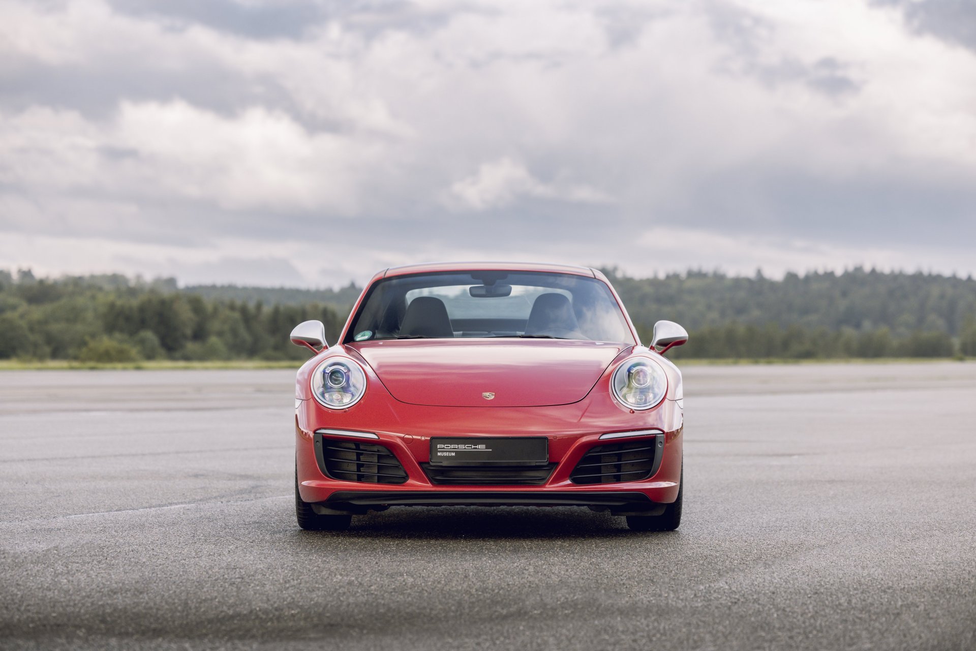 991.1-Gen Porsche 911 Buyer Guide: Pictured here is a Red 991.1 Coupe - front on tarmac. Credit: Porsche AG