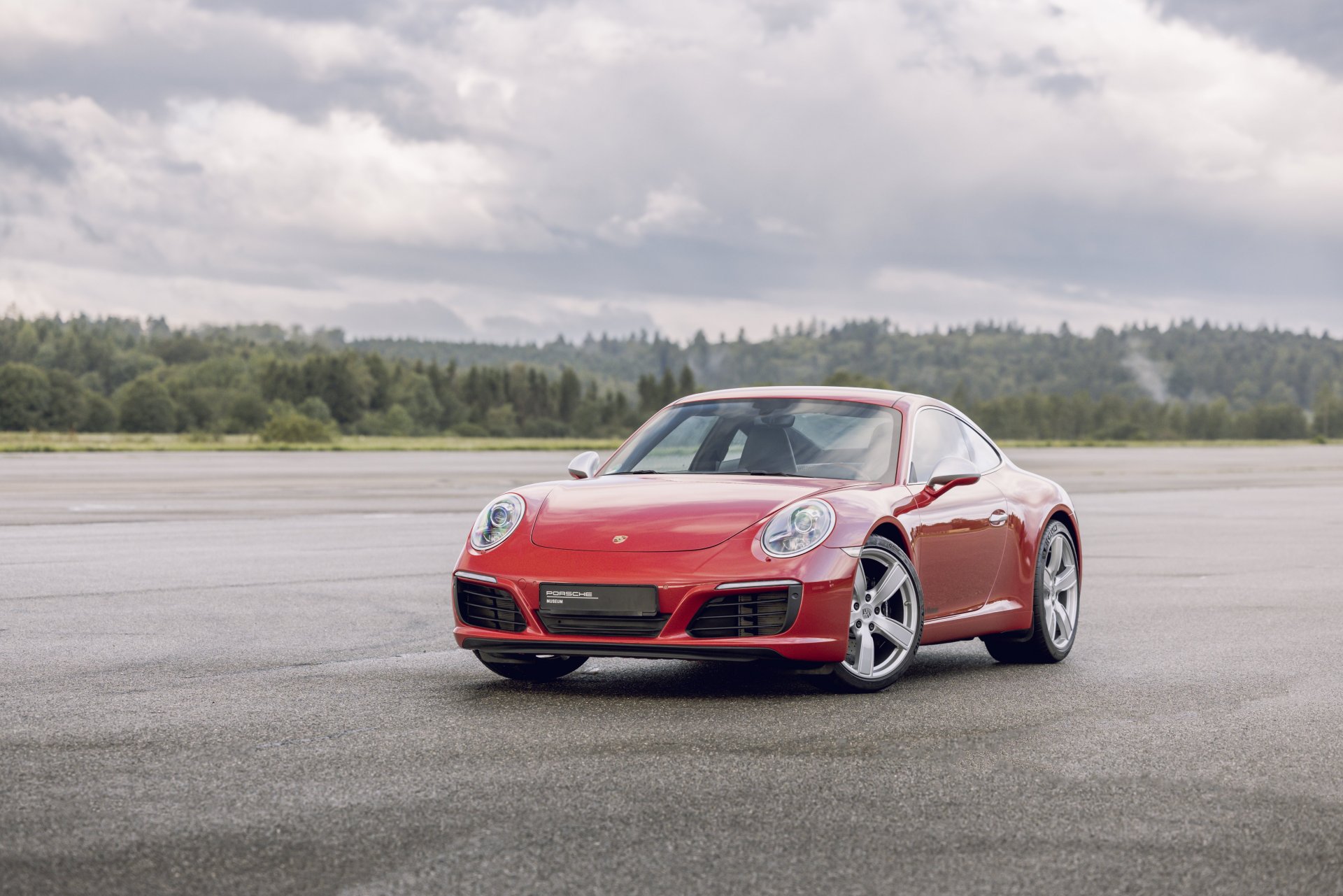991.1-Gen Porsche 911 Buyer Guide: Pictured here is a Red 991.1 Coupe - left-front on tarmac. Credit: Porsche AG