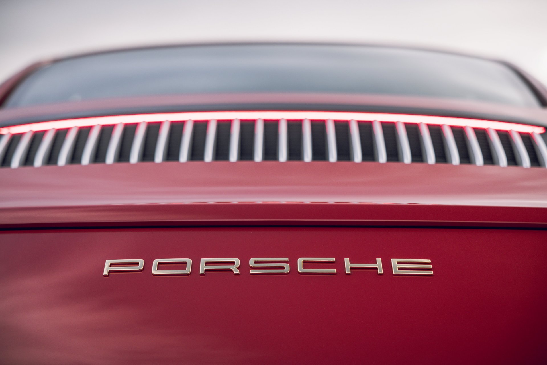 991.1-Gen Porsche 911 Buyer Guide: Pictured here is a Red 991.1 Coupe's rear Porsche font badging straight on. Credit: Porsche AG
