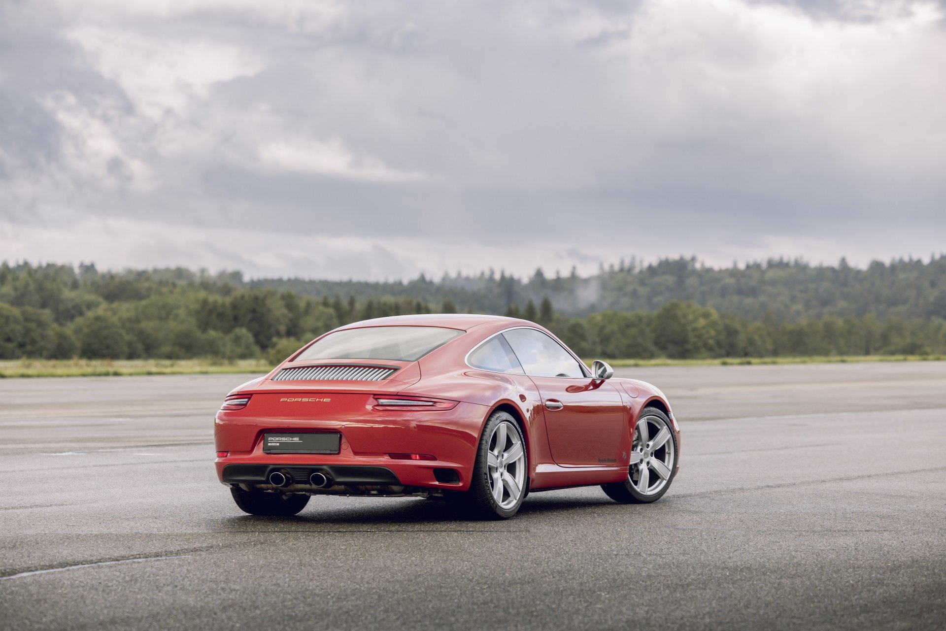 991.1-Gen Porsche 911 Buyer Guide: Pictured here is a Red 991.1 Coupe - right-rear on tarmac. Credit: Porsche AG
