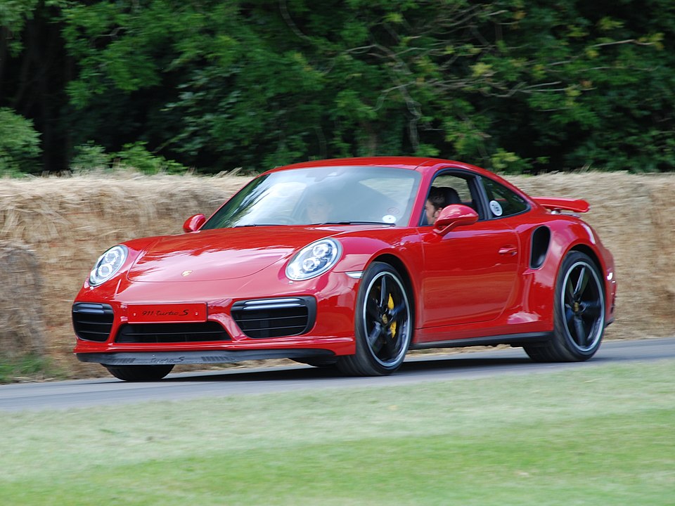 991.1-Gen Porsche 911 Buyer Guide: Red 991.1 Turbo - left-front at speed at 2016 Goodwood. Credit: Matthew Lamb
